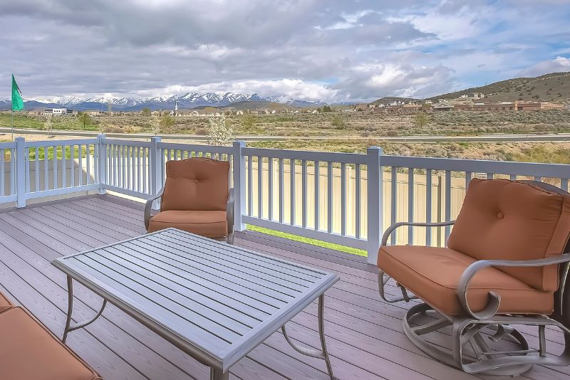 raised composite deck with two rocking chairs and a table