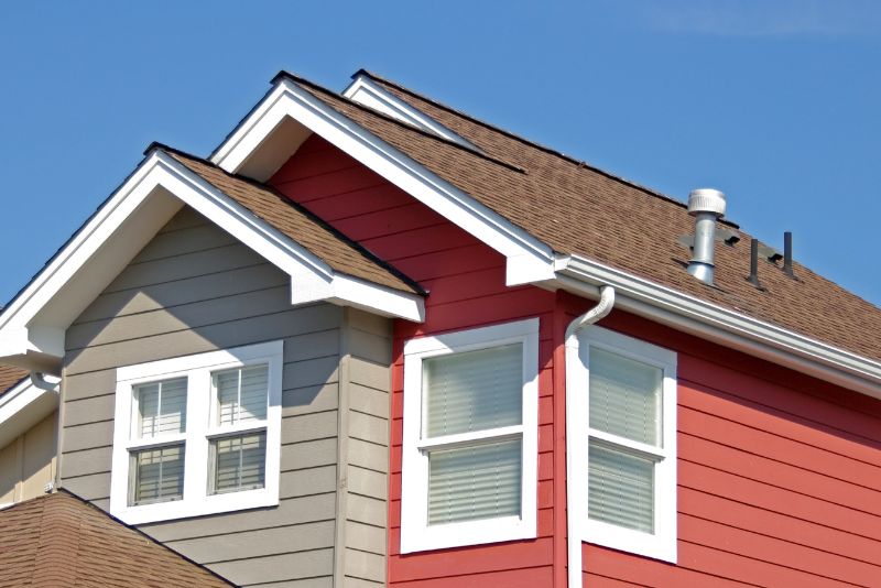 brown roof, white eaves and grey and red walls